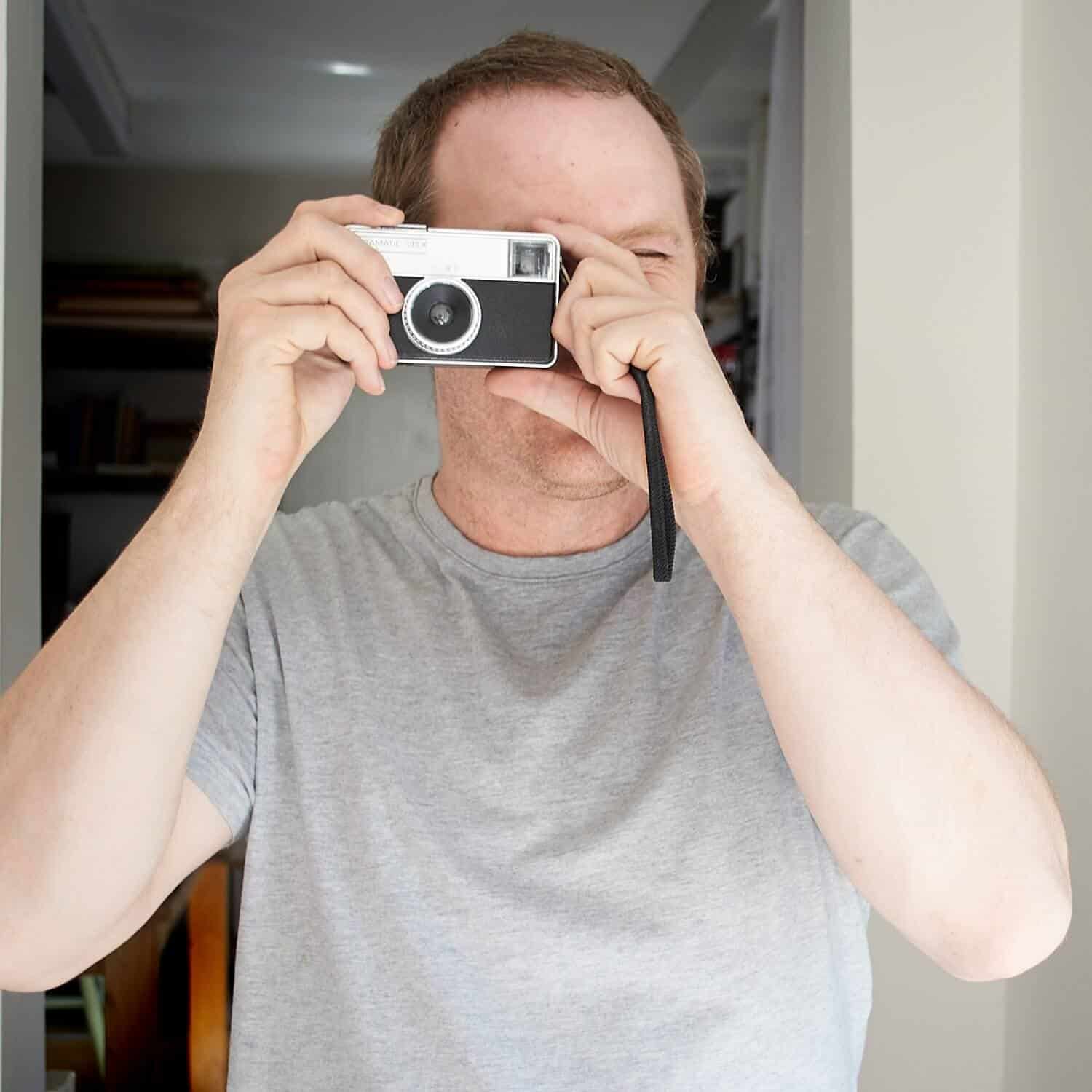 Portrait of Richard Jackson of Forever Creative showing one of the vintage cameras from the studios prop store